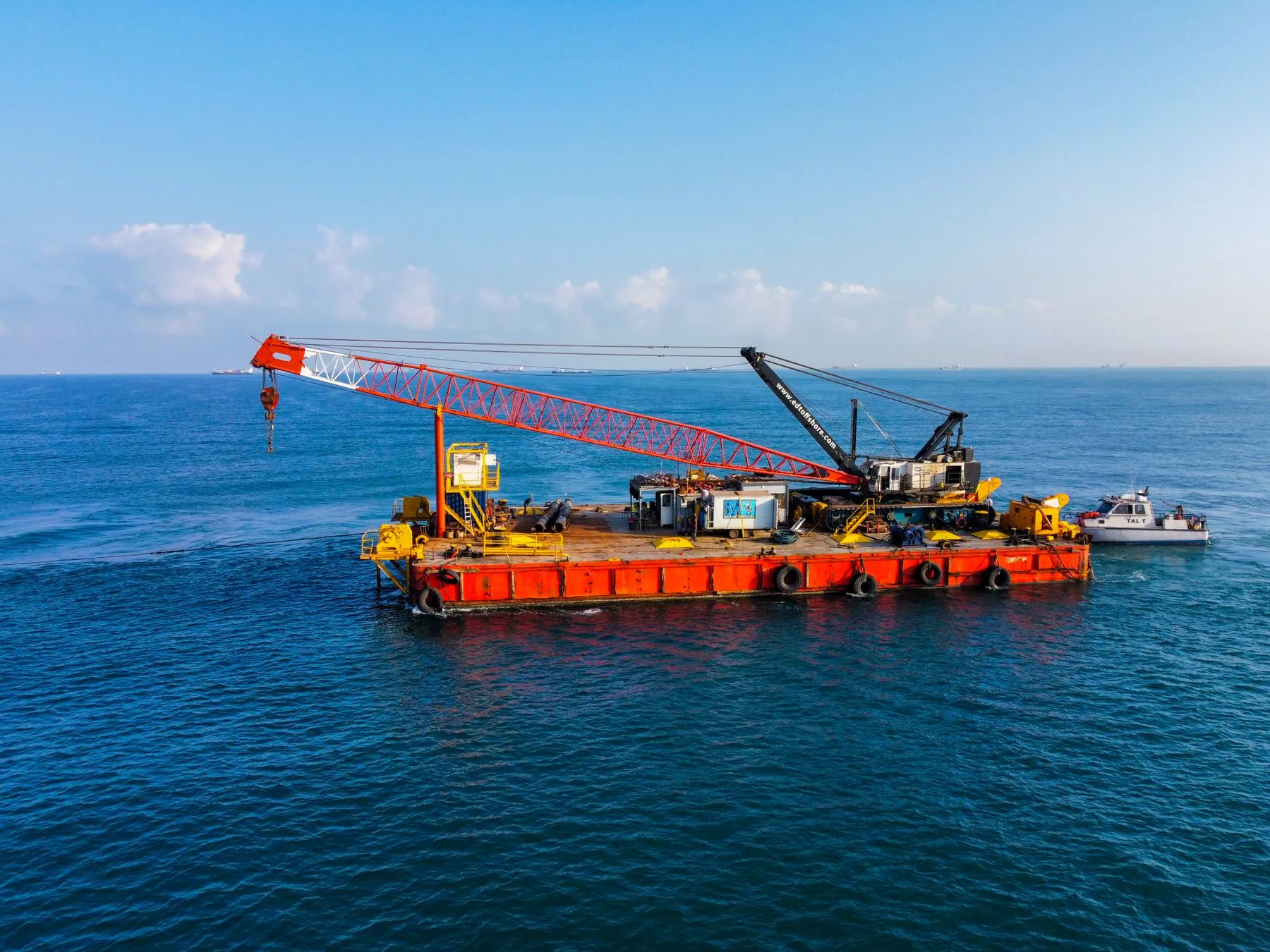 A barge carrying heavy cranes at sea