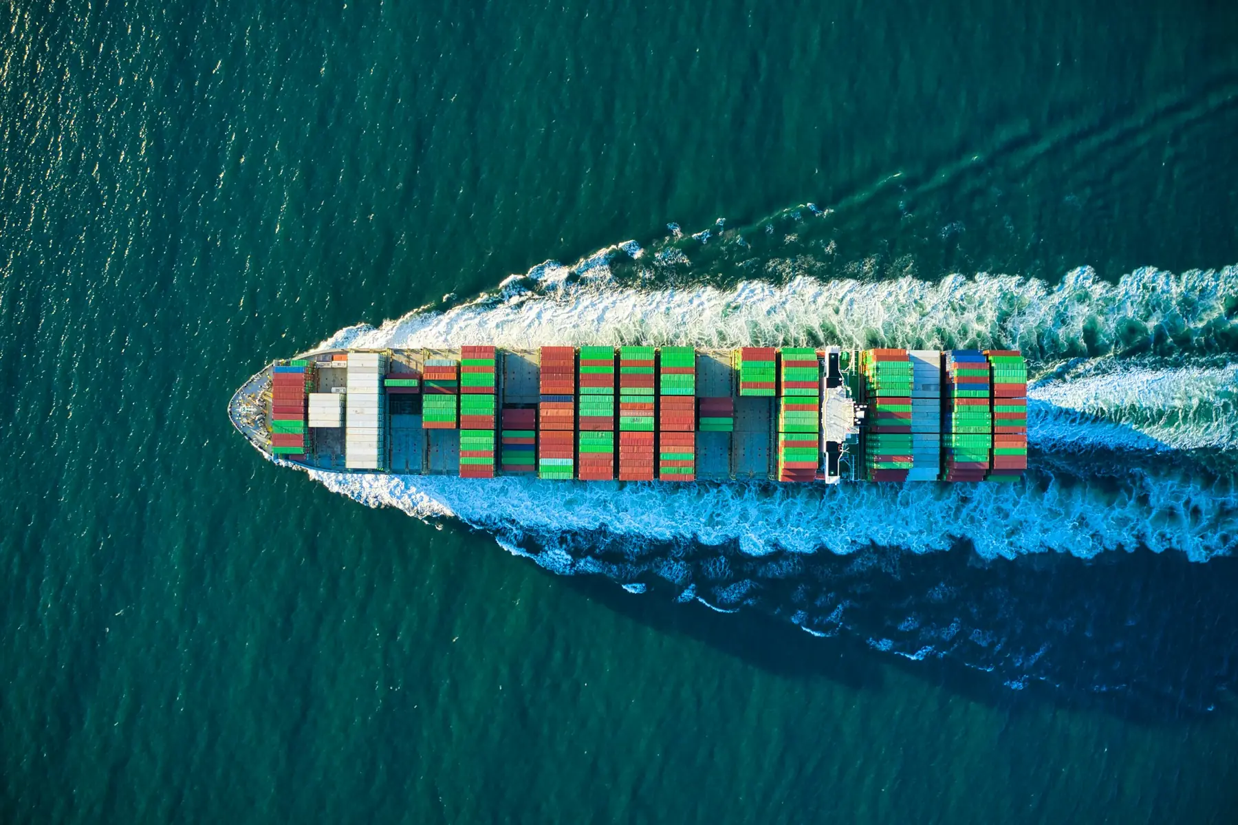 An aerial view of a loaded container ship at sea