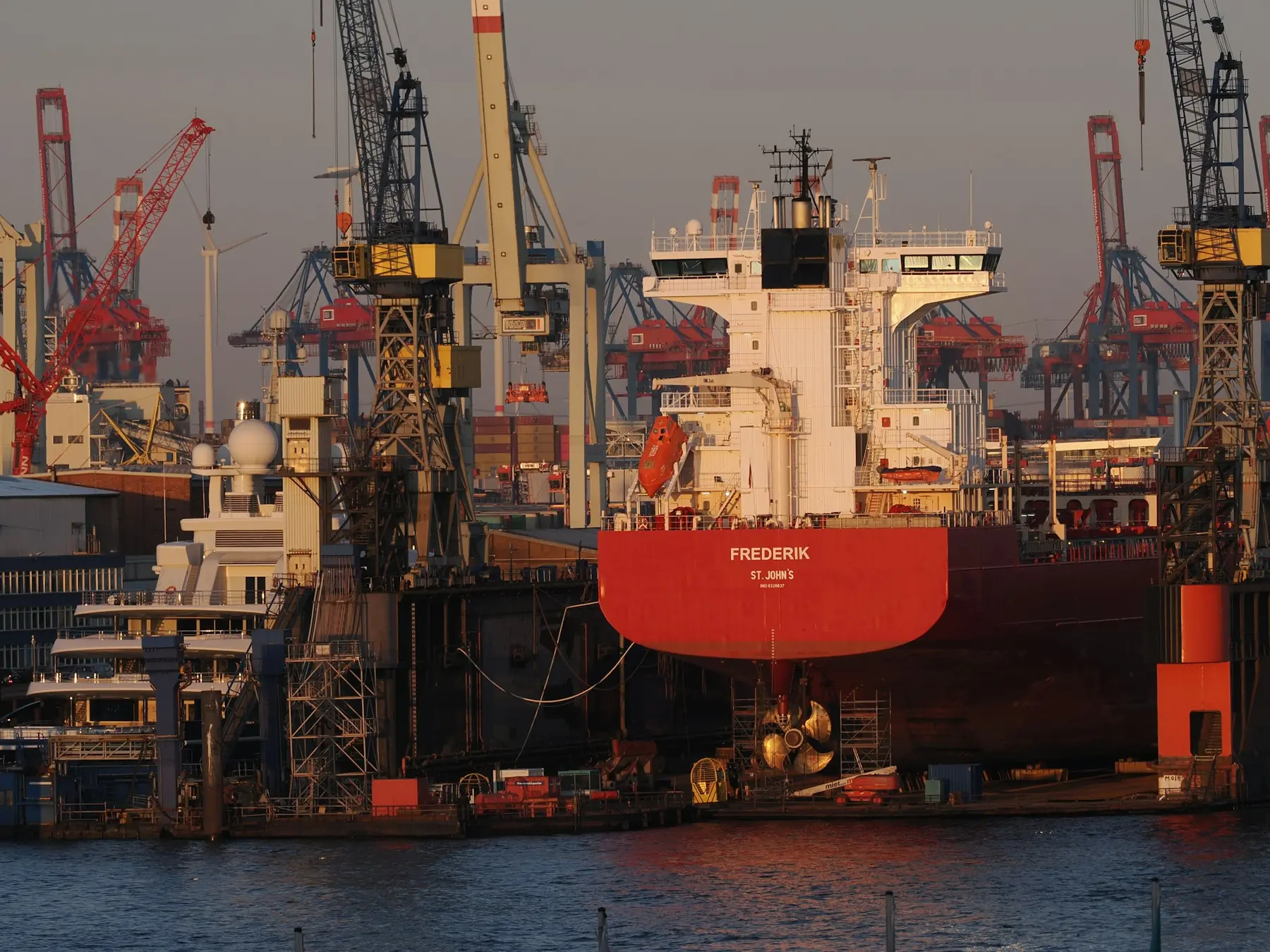 A large ship undergoing repairs in a floating dry dock