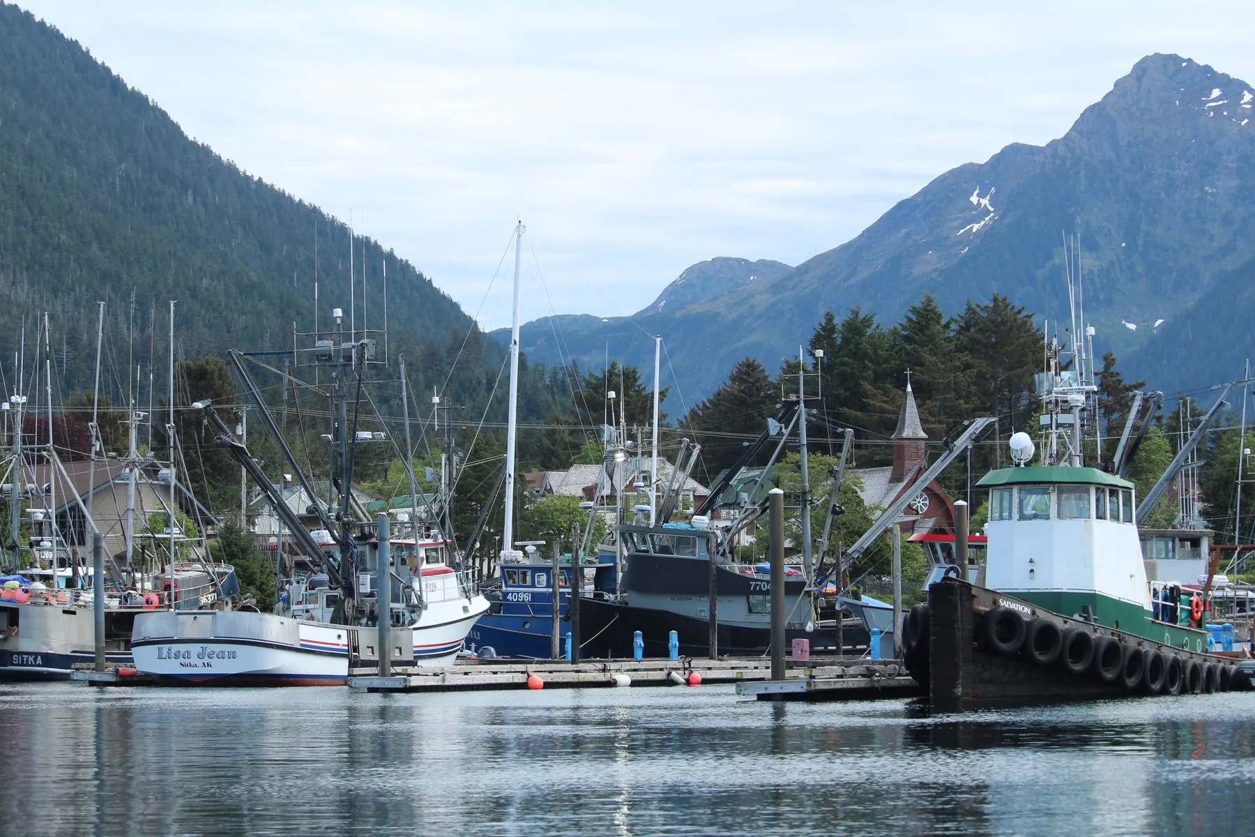 Fishing boats in the harbor at Sitka, Alaska, under the mountains