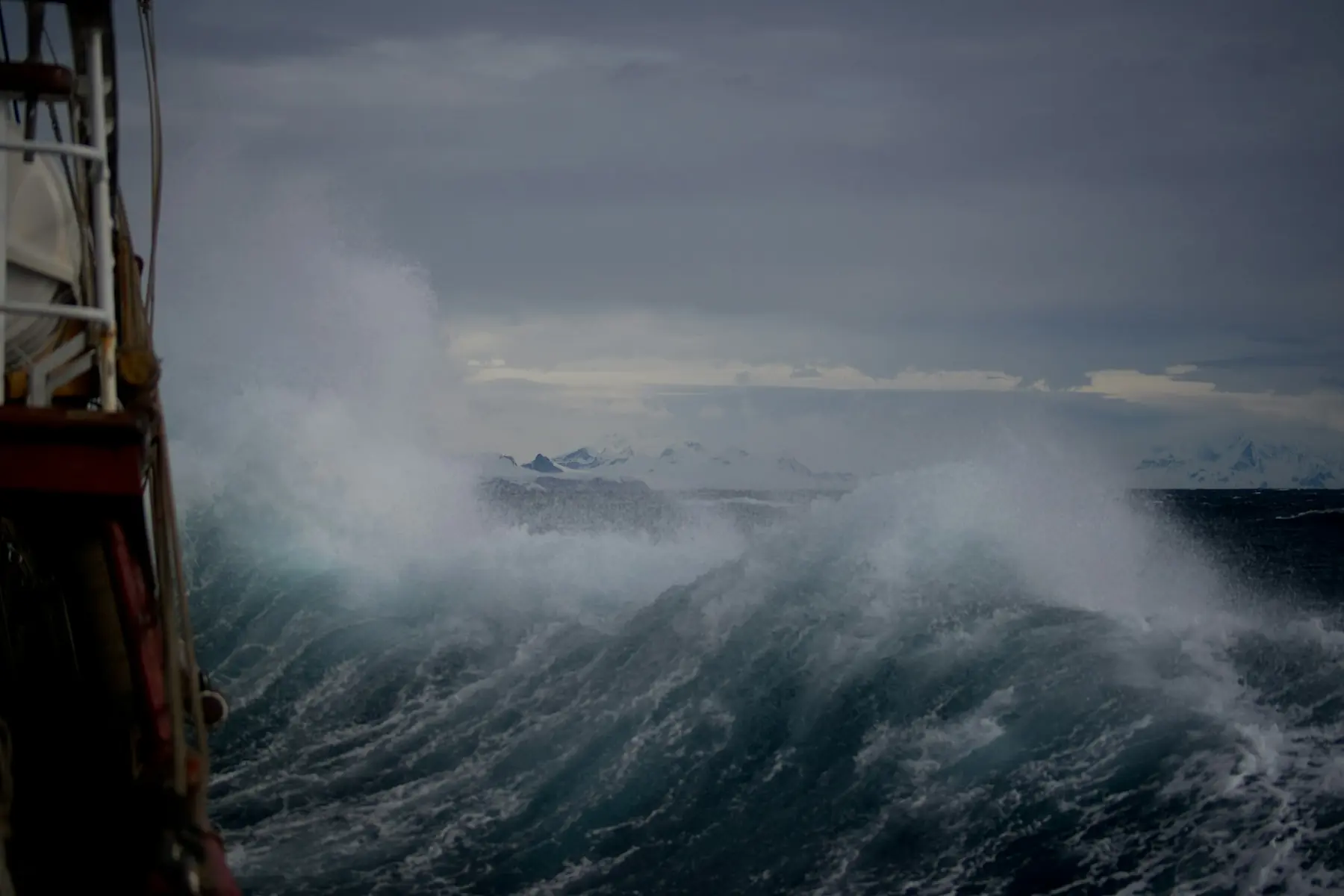 Heavy seas breaking over the bow of a vessel