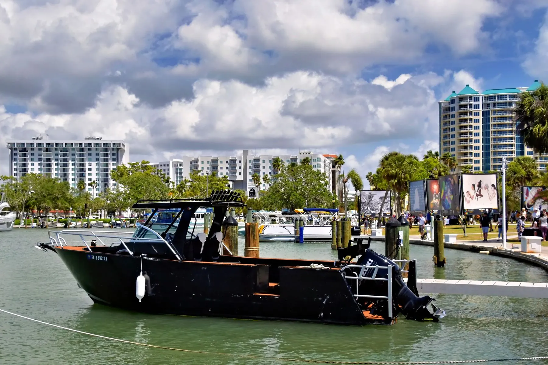 A boat tied up at a marina in Sarasota, Florida, with the city behind