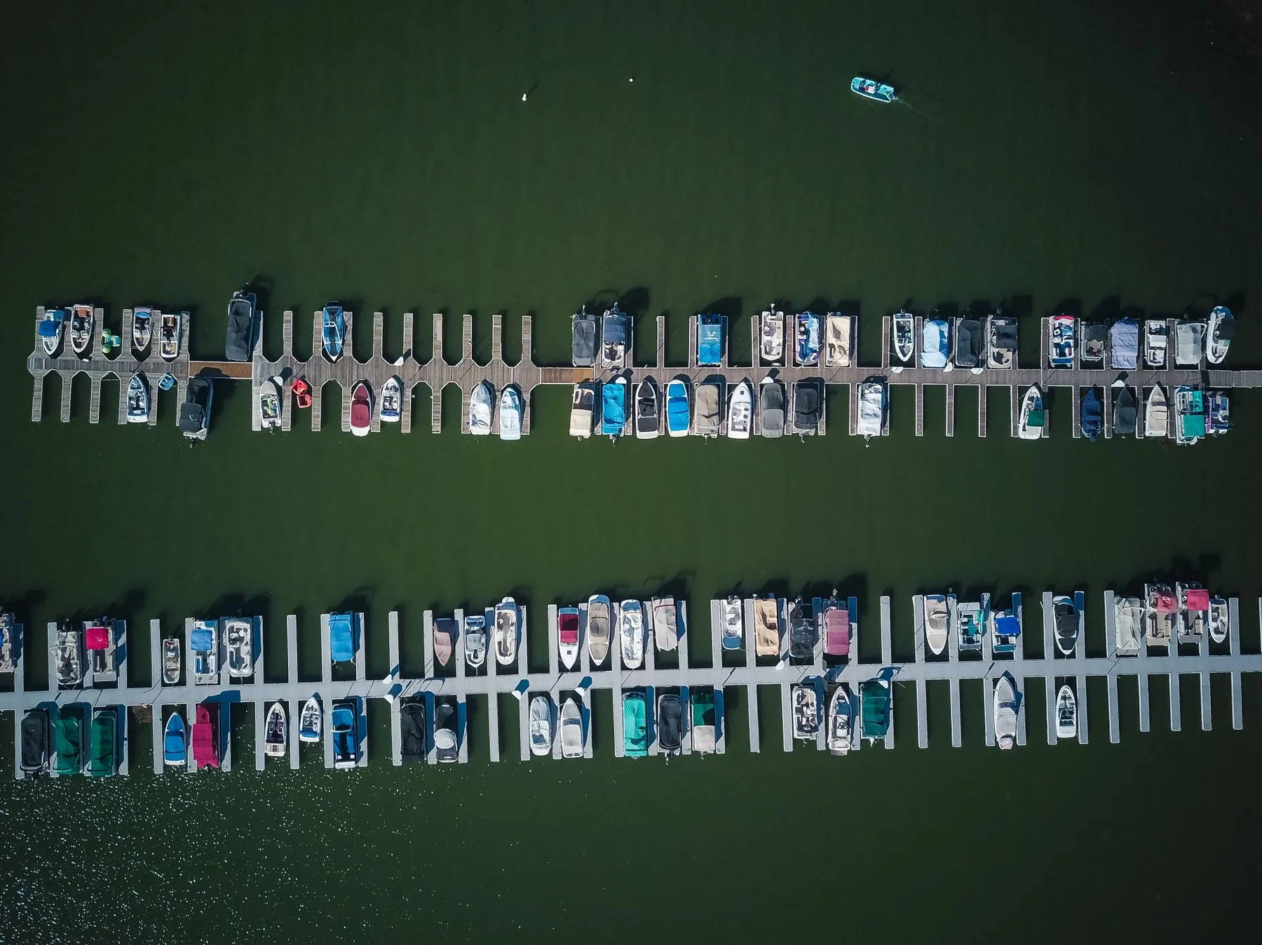 An aerial view straight down on boats in their slips
