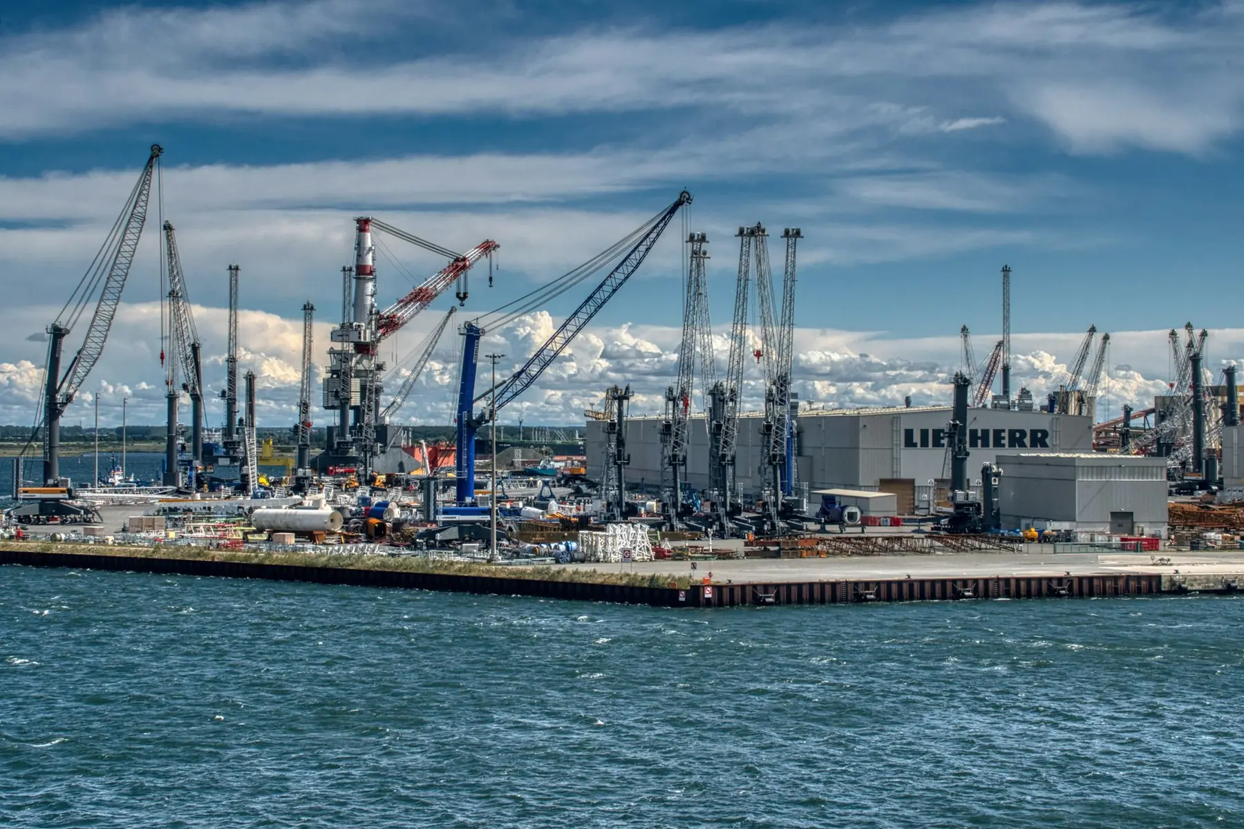 An industrial port with cranes and buildings along the water
