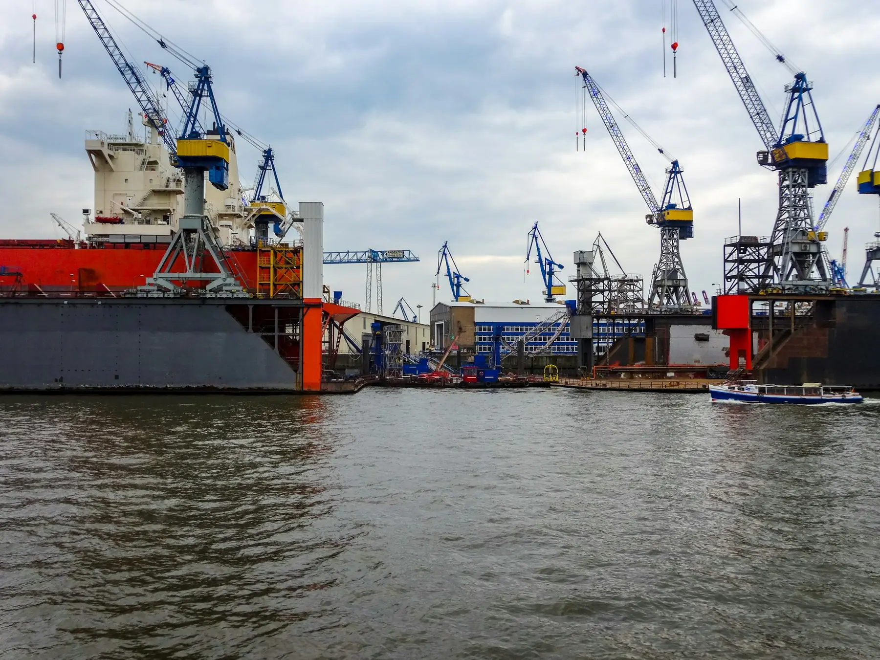 A shipyard with cranes and vessels alongside