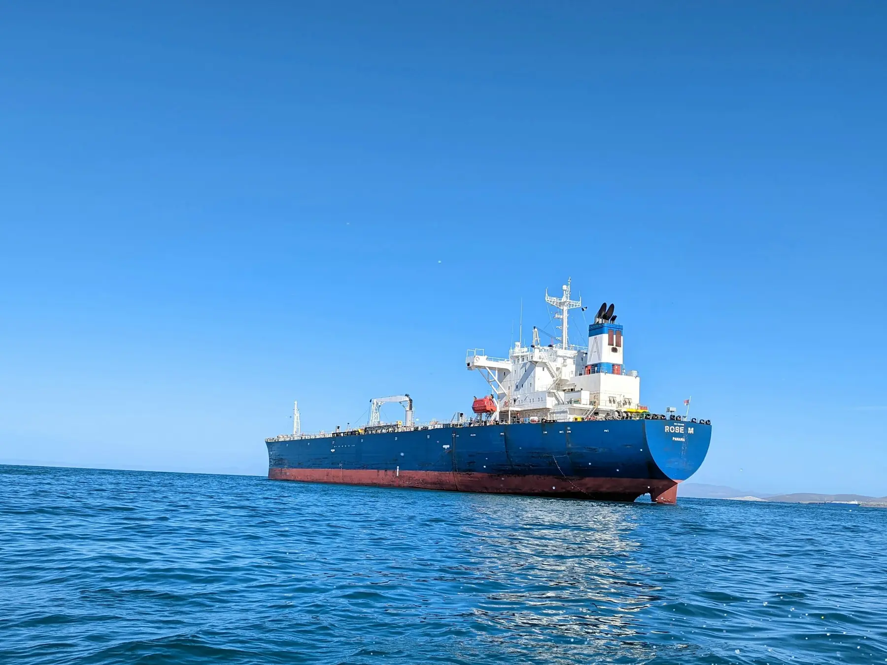 A tanker at anchor on calm blue water