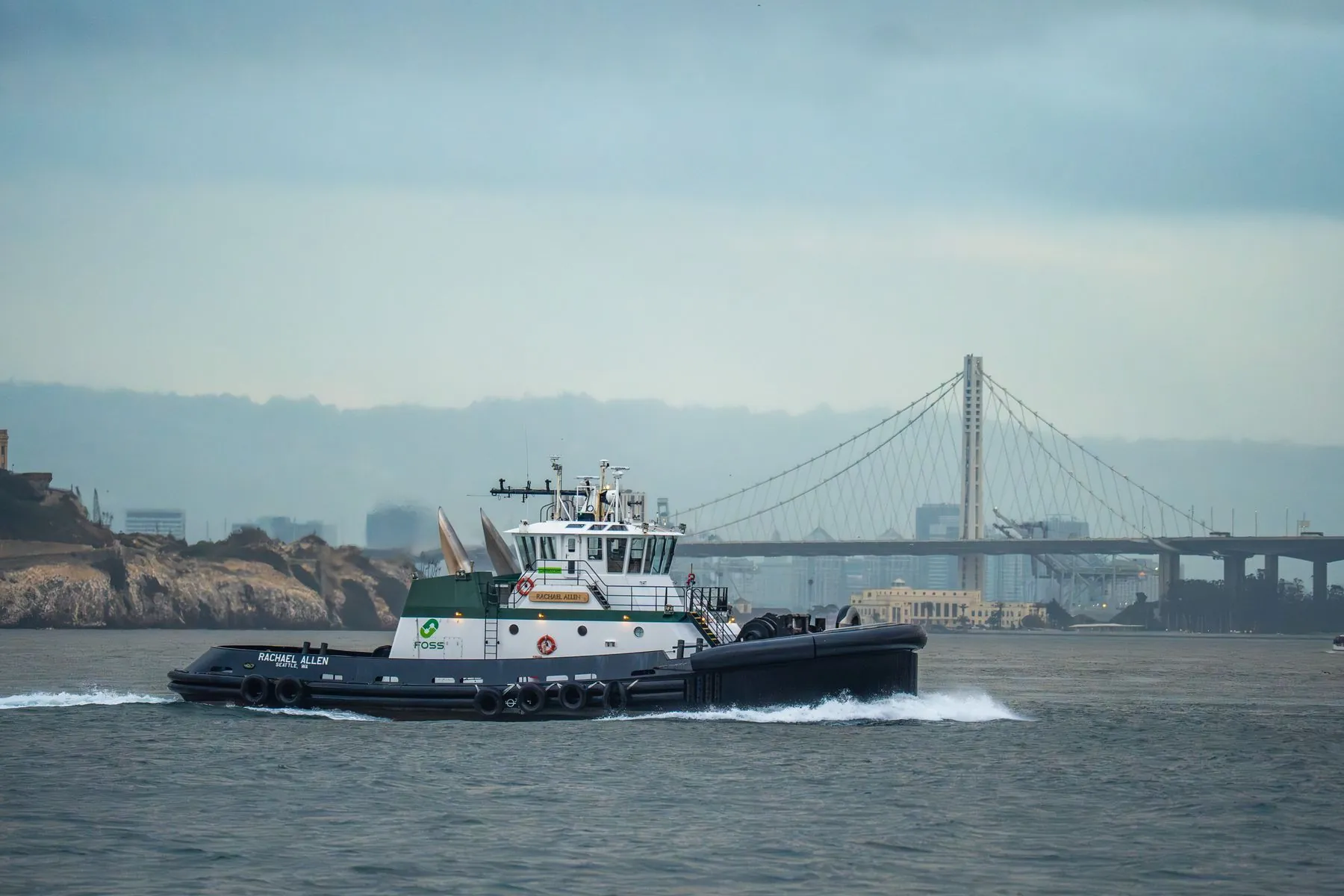 A tug underway on San Francisco Bay with the Bay Bridge behind